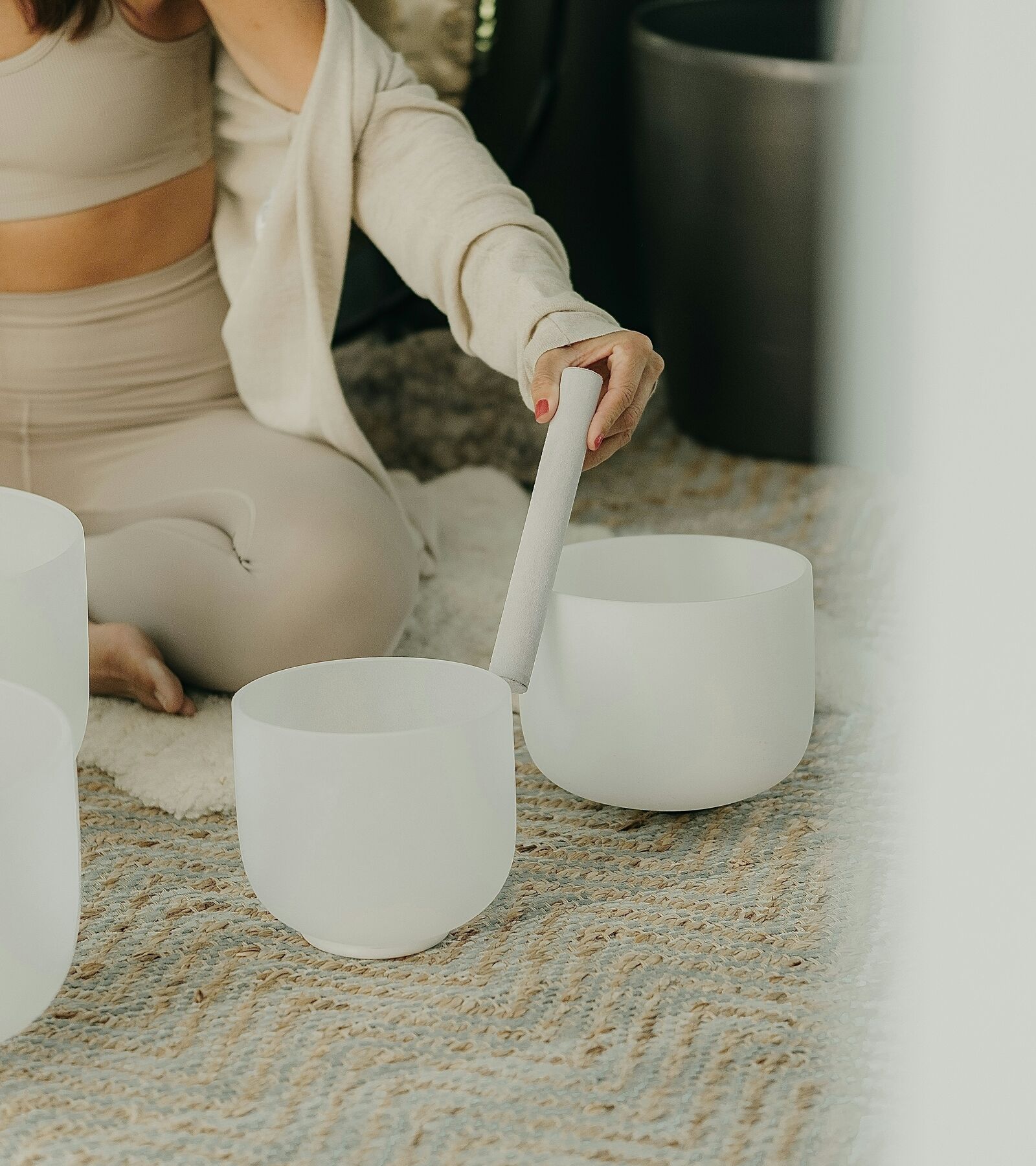 A wellness practitioner leading a crystal singing-bowl session